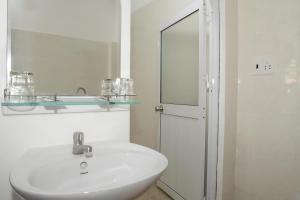 a white bathroom with a sink and a mirror at Nhà Nghỉ Vườn Oải Hương LAVENDER GARDEN GUEST HOUSE in Phu Quoc +48 photos