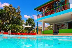 a large swimming pool in front of a house at Chalet Villa Mar in Armenia