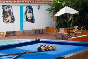 a pool table with billiard balls and an umbrella at Chalet Villa Mar in Armenia