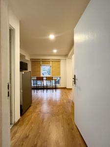 an empty living room with a kitchen and a table at Ananya Apartments Phase 2 in Kathmandu