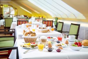 a row of white tables with food on them at Churfürstenhof Wellnesshotel in Bad Birnbach