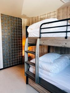 a couple of bunk beds in a room at KIIIYA cafe&hostel in Azumino