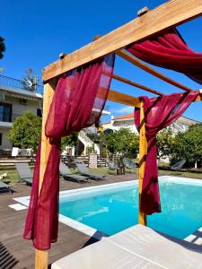 a canopy over a pool in front of a resort at Alice House 2 in Amarynthos