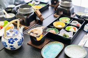 a table topped with plates of food and sushi at glampark Shikisou Shimane in Izumo