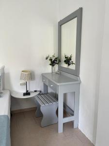 a white dressing table with a mirror and a lamp at Villa Mertiza in Myrtos