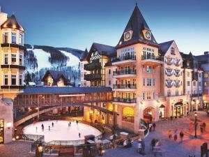 a group of buildings with an ice rink in front at Vail Arrabelle 2 Bedroom Residence in Vail