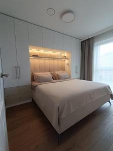 Ένα ή περισσότερα κρεβάτια σε δωμάτιο στο Luxury Vanagupė Apartments & SPA