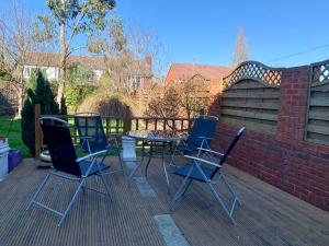 a group of chairs and a table on a patio at Somerford Place - 6 Beds - Sleeps 12 - Parks 2-3 cars/vans in Willenhall