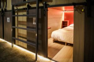 a room with a bed and a sliding glass door at Cinema Capsules in Jerusalem
