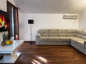 a living room with a couch and a table at Family Residence Petrovac in Petrovac na Moru