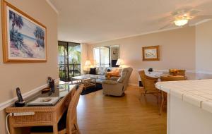 a living room with a kitchen and a dining room at Kauhale Makai 506 in Kihei