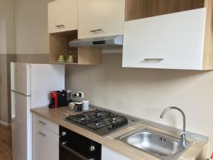 a kitchen with a sink and a stove at Casa De Angelis in Castellanza