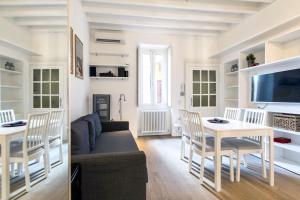 uma sala de estar com um sofá e uma mesa em Lovely apartment on the Navigli river by Easylife em Milão