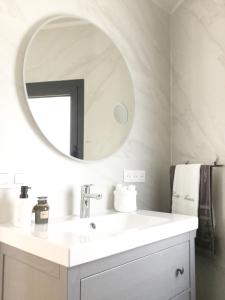 a bathroom with a white sink and a mirror at Lodge Marie in Villegailhenc +34 photos