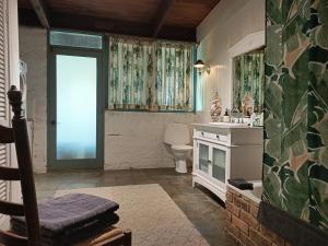 a bathroom with a toilet and a sink and a window at Macedon Ranges Glamping in Macedon