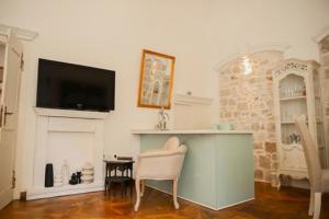 a living room with a fireplace and a tv at Elephant in my room in Dubrovnik
