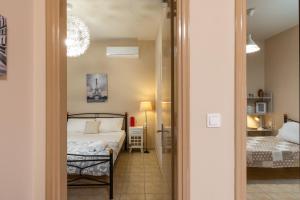 a bedroom with a bed and a small room at City Suite in Kefalonia in Argostoli