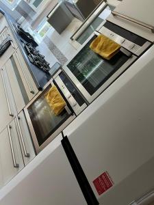 a kitchen with a white refrigerator with a counter top at כשר in Hendon