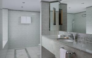 a bathroom with a sink and a mirror at JW Marriott Bucharest Grand Hotel in Bucharest