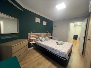 a bedroom with a bed and a dresser and a mirror at Vibes Coruña- Estancia moderna en Eiris in A Coruña