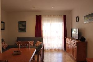 A television and/or entertainment centre at Delfines II Solo Familias Serviplaya