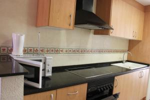 A kitchen or kitchenette at Delfines II Solo Familias Serviplaya