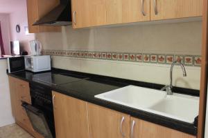 A kitchen or kitchenette at Delfines II Solo Familias Serviplaya