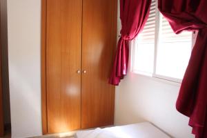 A bed or beds in a room at Delfines II Solo Familias Serviplaya