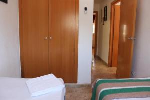 A bed or beds in a room at Delfines II Solo Familias Serviplaya