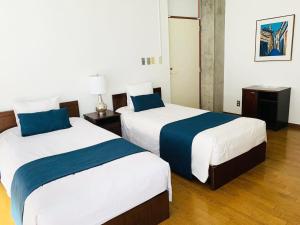 Ένα ή περισσότερα κρεβάτια σε δωμάτιο στο 24時間源泉掛け流しGuest House Belle Hakone