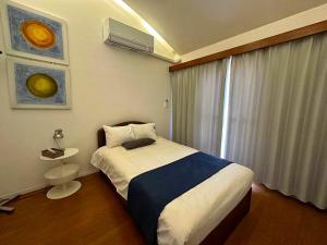 Ένα ή περισσότερα κρεβάτια σε δωμάτιο στο 24時間源泉掛け流しGuest House Belle Hakone