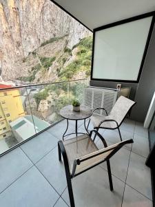a room with a table and a chair and a screen at Modern Apartment with Spa and Pool in Gibraltar