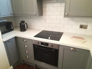 a kitchen with a sink and a stove top oven at Kirkcudbright Holiday Apartments - Apartment C in Kirkcudbright