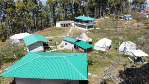 an aerial view of a house with a green roof at Nitya Village Retreat in Chamba