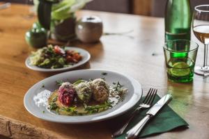 a wooden table with two plates of food on it at Riatschhof in Nauders