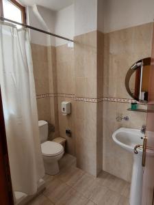 a bathroom with a toilet and a sink at Guesthouse Bimbli in Pogradec