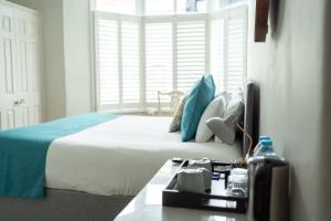 a bedroom with a large bed and a window at INNit Marina in Brighton & Hove