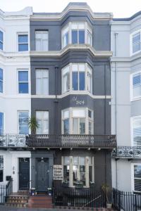 an apartment building with a black and white facade at Brighton Marina House in Brighton & Hove