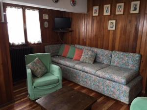 a living room with a couch and a chair at Stella Alpina sotto al Cervino in Breuil-Cervinia