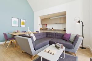 a living room with a couch and a table at Buckie - 2 Bed Luxury Apartment in Wick