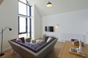 a living room with a couch and a table at Buckie - 2 Bed Luxury Apartment in Wick