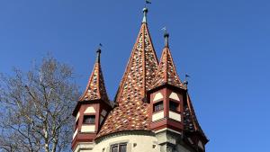 un bâtiment avec trois tours en haut dans l'établissement Laura, à Äschach