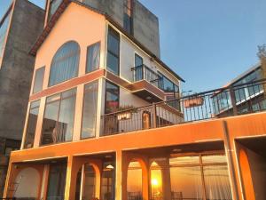 an orange and white building with a balcony at Wonderland Homestay - Venuestay in Vĩnh Phúc