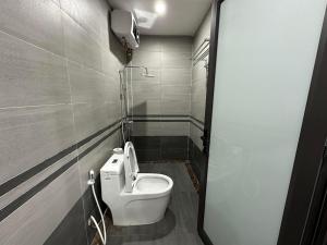 a bathroom with a white toilet in a stall at Wonderland Homestay - Venuestay in Vĩnh Phúc