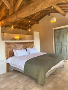 a bedroom with a large bed with wooden ceilings at Les Demeures de Piana in Piana