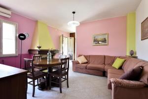 a living room with a couch and a table at 3 - Casa con giardino Lotzorai - Sa Crai Apartments Sardinian Experience in Lotzorai