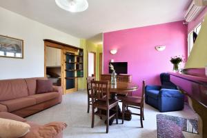 a living room with a couch and a table at 3 - Casa con giardino Lotzorai - Sa Crai Apartments Sardinian Experience in Lotzorai