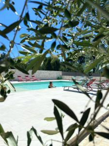 a person is sitting in a swimming pool at Agriturismo B&B TorreBianca in Manduria