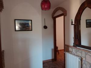 a hallway in a house with a fireplace and a mirror at Casita Vista Alegre in Castril
