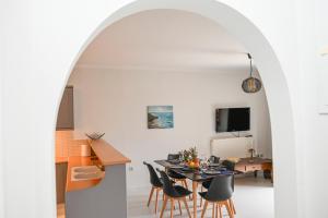 a kitchen and dining room with a table and chairs at Santamare Apartment in Agios Sostis